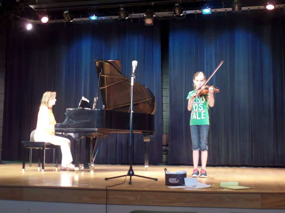 Laura practicing for her violin recital in 2014.