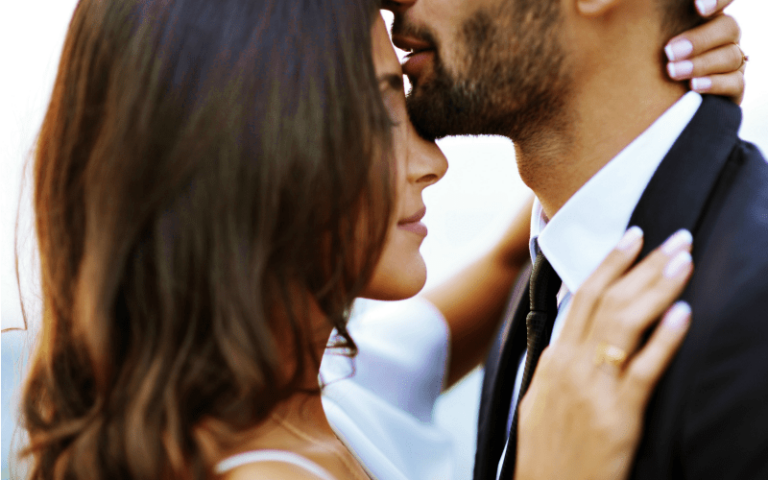 A husband kissing his wife on the forehead. |15 Ways to Bless Your Marriage @ AVirtuousWoman.org